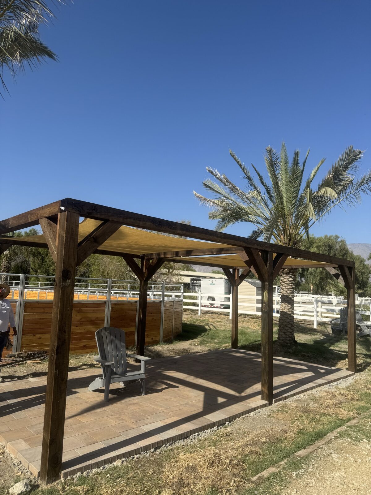 Long covered pergola walkway structure with support posts