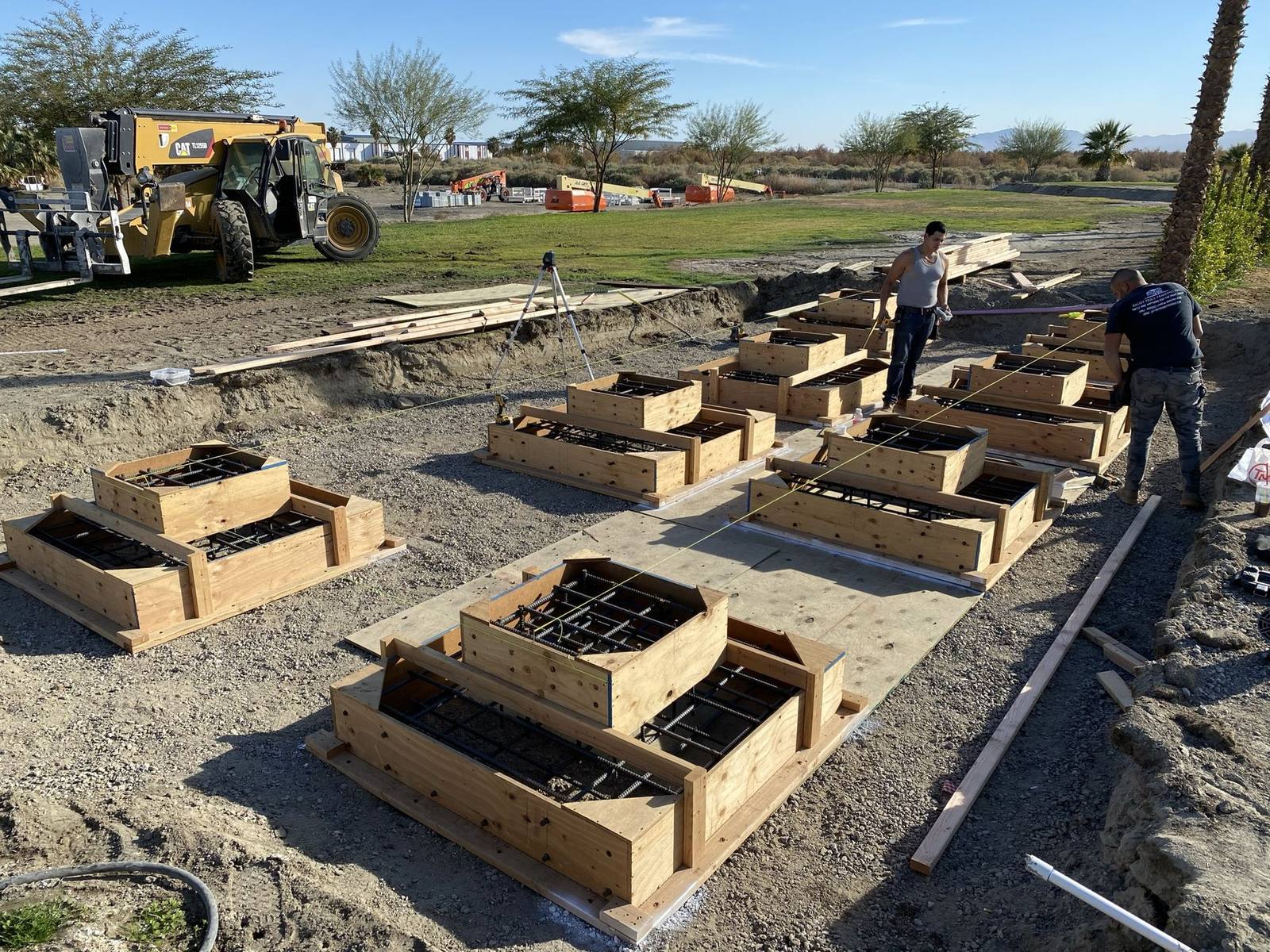 Crew setting rebar and foundation forms on a commercial project