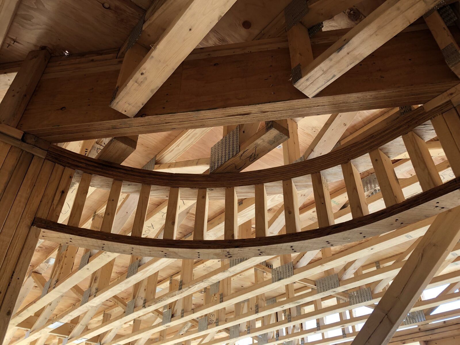 Close-up of a curved custom roof truss detail in a framed structure